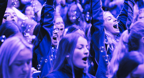 Photograph of a group of young girls cheering at the Shine Festival from The Shona Project, an annual event held to empower young women in Ireland