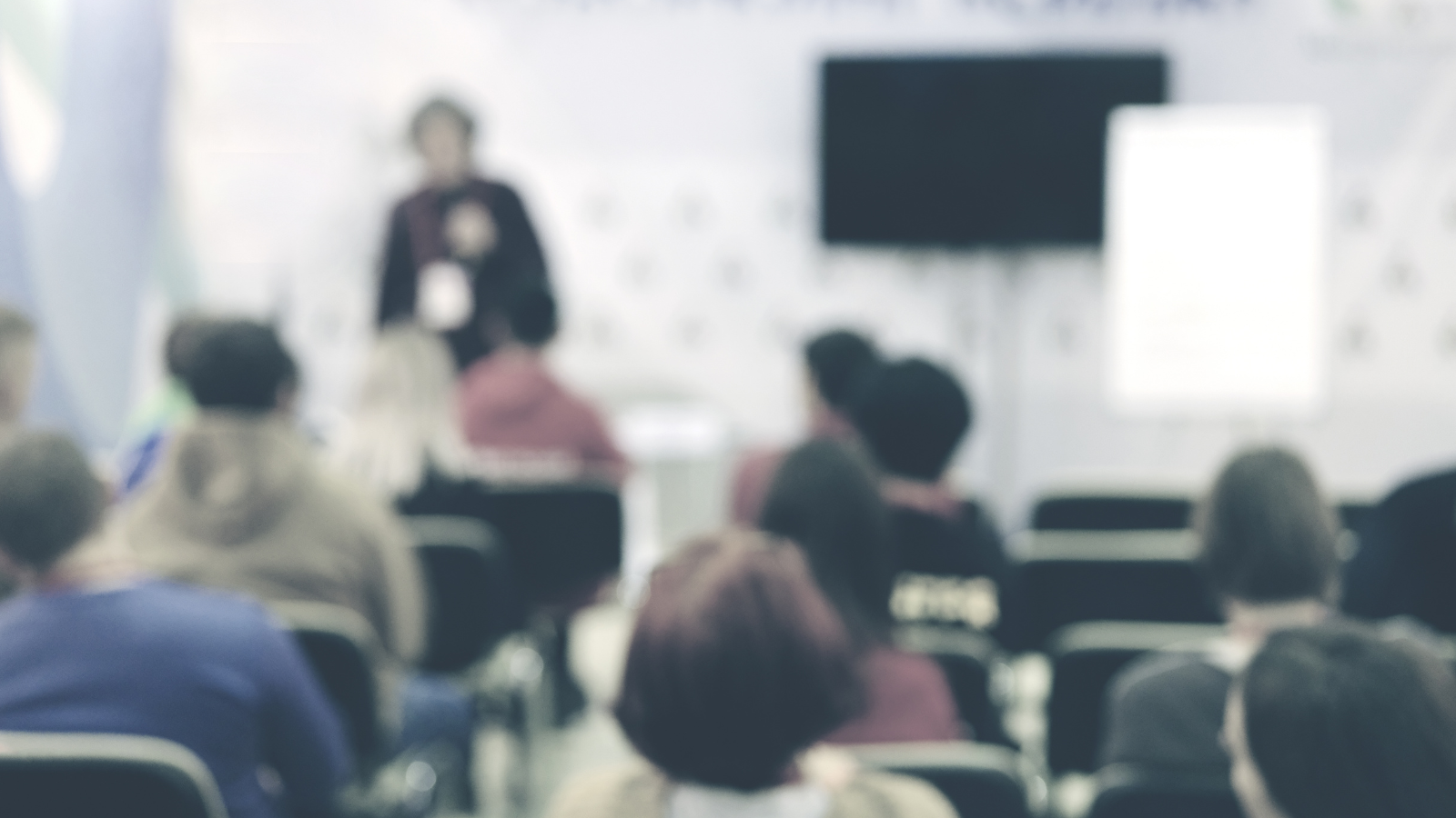 This is an image of a secondary school classroom with students and teacher in a blurred background.